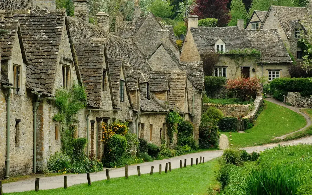 Stone weavers' cottages of Arlington Row in Bibury on a small group Cotswolds day trip from London
