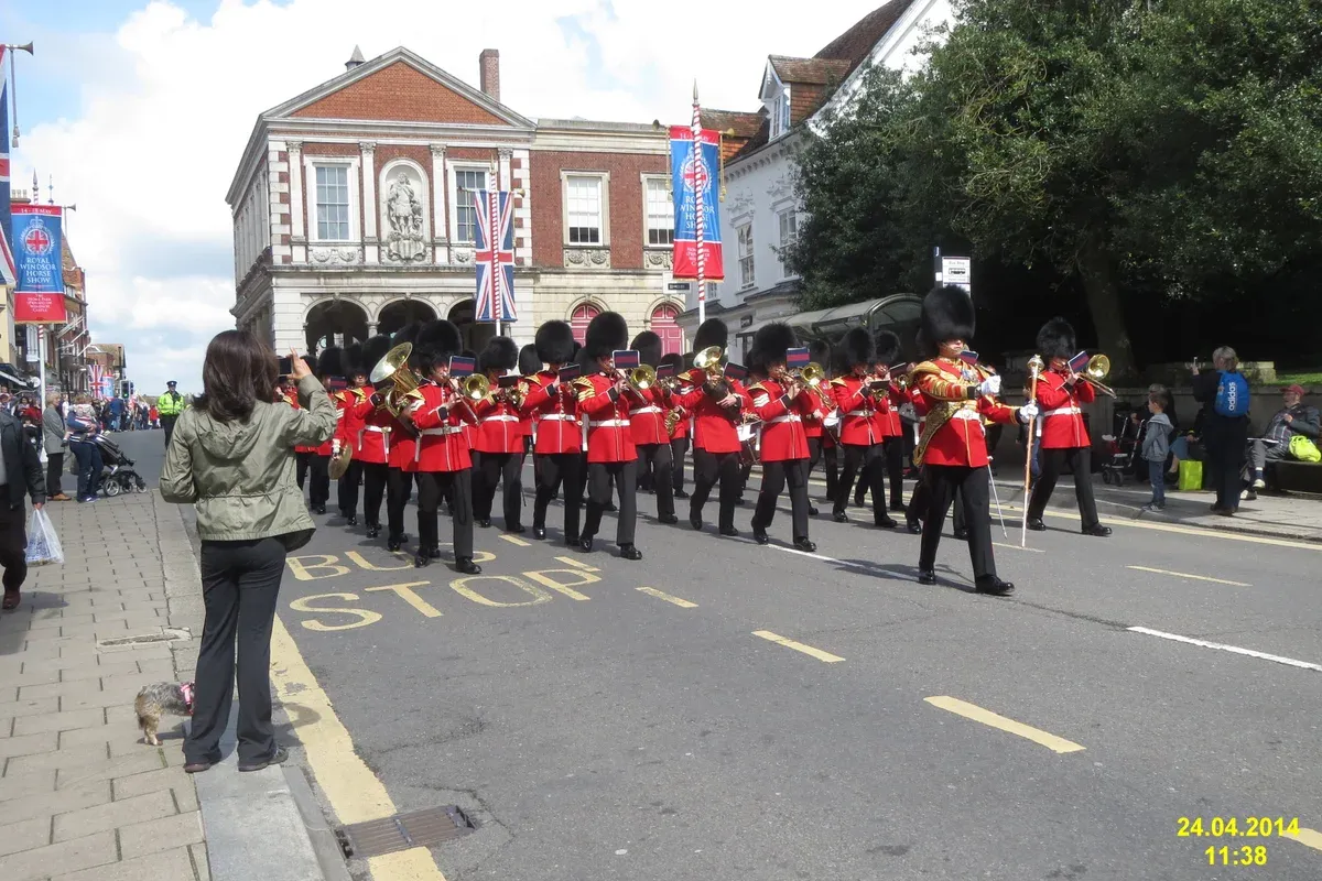 Guards marching in a Windsor street during the Changing of the Guard on a day trip from London to Windsor Castle
